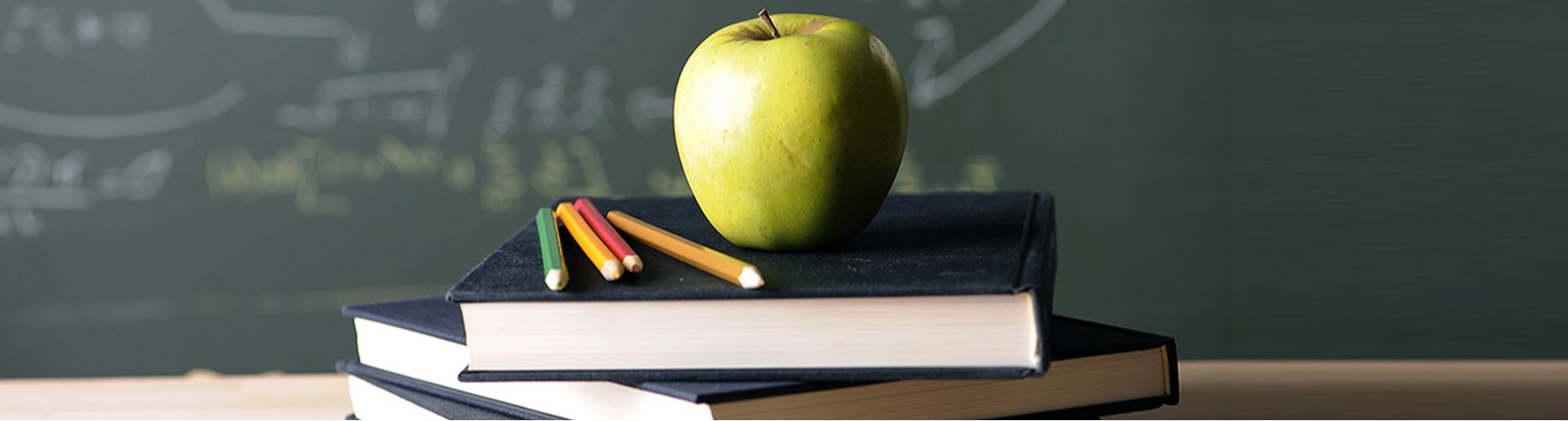 Apple with pencils and books