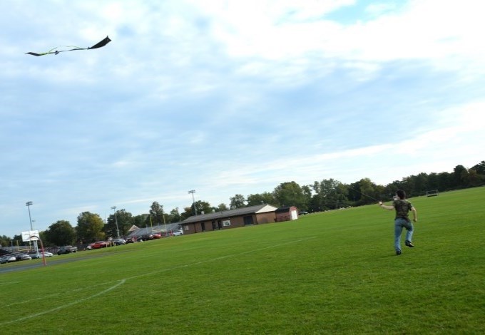 Student runs with a kite