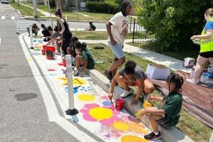 children painting a curb bump out