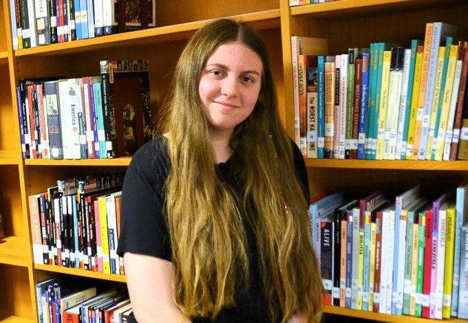 Emily smiles for a photo in the Clarence High School library.